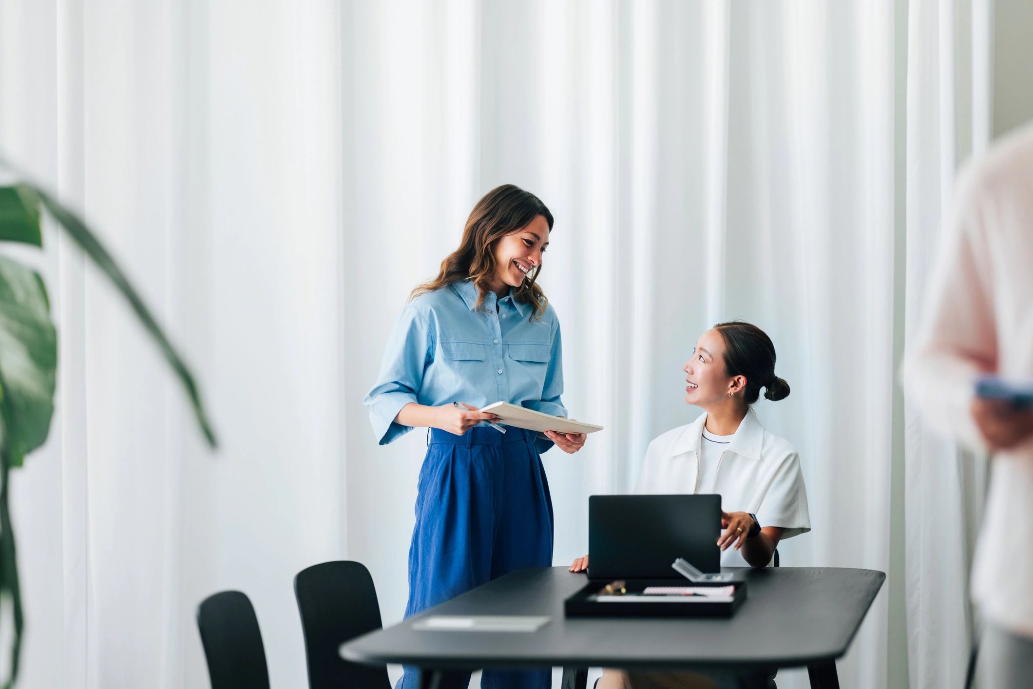 Two professionals collaborating at a modern office desk